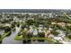 Wide aerial view of a residential area with a focus on a home nestled by a lake at 289 Whisper Lake Rd, Palm Harbor, FL 34683