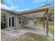 Covered patio with brick pavers, wood beams, and a ceiling fan at 289 Whisper Lake Rd, Palm Harbor, FL 34683