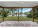 View of the backyard, with a covered patio and pond at 289 Whisper Lake Rd, Palm Harbor, FL 34683