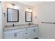 Bright bathroom with a double sink vanity, granite countertops, and modern square mirrors at 289 Whisper Lake Rd, Palm Harbor, FL 34683