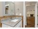 Bathroom vanity featuring granite countertops, an undermount sink, and a view of the living area at 289 Whisper Lake Rd, Palm Harbor, FL 34683