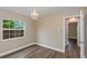 Well-lit bedroom with wood floors, trim, and a clear window looking to the exterior at 289 Whisper Lake Rd, Palm Harbor, FL 34683