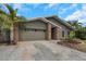 Charming single-story home features a two-car garage, lush landscaping, and a welcoming front entrance at 289 Whisper Lake Rd, Palm Harbor, FL 34683