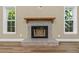 Cozy stone fireplace with wooden mantle and windows on either side at 289 Whisper Lake Rd, Palm Harbor, FL 34683