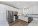 Modern kitchen with stainless steel appliances and white cabinetry at 289 Whisper Lake Rd, Palm Harbor, FL 34683