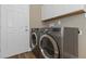 The laundry room features a washer and dryer, cabinets, and wood-look floors at 289 Whisper Lake Rd, Palm Harbor, FL 34683