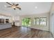 Inviting living area with hardwood floors, a modern kitchen, and sliding glass doors offering outdoor views at 289 Whisper Lake Rd, Palm Harbor, FL 34683