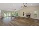 Spacious living room with hardwood floors, a fireplace, and lots of natural light at 289 Whisper Lake Rd, Palm Harbor, FL 34683