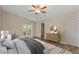 Inviting main bedroom featuring a ceiling fan and double doors to patio at 289 Whisper Lake Rd, Palm Harbor, FL 34683