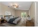 Tranquil main bedroom featuring a ceiling fan and patio doors at 289 Whisper Lake Rd, Palm Harbor, FL 34683