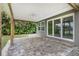 Covered patio with brick pavers and a view of the backyard at 289 Whisper Lake Rd, Palm Harbor, FL 34683