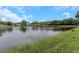 View of neighborhood pond with blue sky at 289 Whisper Lake Rd, Palm Harbor, FL 34683