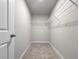 Carpeted walk-in closet with wire shelving at 2764 Emory Sound Pl, Brandon, FL 33510