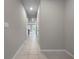 Hallway with tiled floors featuring neutral paint and recessed lighting, leading to various rooms at 2764 Emory Sound Pl, Brandon, FL 33510