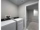 A laundry room has a washer and dryer and a tiled floor at 2764 Emory Sound Pl, Brandon, FL 33510