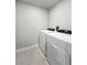 A laundry room shows a washer and dryer on a tiled floor at 2764 Emory Sound Pl, Brandon, FL 33510