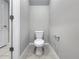 Powder room with a modern toilet, neutral paint, and tile floors at 2764 Emory Sound Pl, Brandon, FL 33510