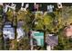 Aerial view of a property showcasing the lush backyard, pool, and boat docks at 3225 Bluff Blvd, Holiday, FL 34691