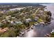 Waterfront property with private boat access, surrounded by mature trees and greenery in a peaceful coastal neighborhood at 3225 Bluff Blvd, Holiday, FL 34691