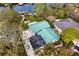 Stunning aerial view of home with a pool, screened lanai, green roof, and waterfront access at 3225 Bluff Blvd, Holiday, FL 34691