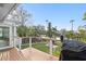 A deck with a grill overlooks a landscaped backyard with a waterfront view at 3225 Bluff Blvd, Holiday, FL 34691