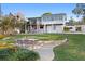 Lush backyard featuring a table with chairs and a view of the home's exterior at 3225 Bluff Blvd, Holiday, FL 34691