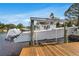 Modern boat lift featuring a large motorboat docked, clear water, and sunny skies at 3225 Bluff Blvd, Holiday, FL 34691