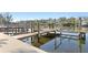 Private boat dock featuring boat lifts, wooden walkways, and access to the tranquil waterway at 3225 Bluff Blvd, Holiday, FL 34691