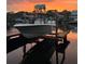 Boat on a lift at sunset on a private dock, perfect for boating enthusiasts at 3225 Bluff Blvd, Holiday, FL 34691