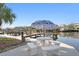 Serene waterfront dock with a picnic table under an umbrella, perfect for relaxing by the water at 3225 Bluff Blvd, Holiday, FL 34691