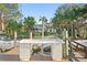 Waterfront property featuring a dock, fish cleaning station, and scenic views of the surrounding nature at 3225 Bluff Blvd, Holiday, FL 34691