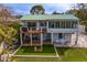 View of the home featuring a backyard patio and lovely landscaping at 3225 Bluff Blvd, Holiday, FL 34691