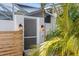 Well-lit exterior of a home featuring a screen door surrounded by lush tropical landscaping at 3225 Bluff Blvd, Holiday, FL 34691