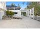 Exterior view of home with white trellis fence, and stone walkway to screened in area at 3225 Bluff Blvd, Holiday, FL 34691