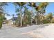 Beautiful home with lush tropical landscaping and charming white gravel driveway at 3225 Bluff Blvd, Holiday, FL 34691