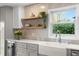 Kitchen detail featuring stainless steel appliances, floating shelves, and a garden window at 3225 Bluff Blvd, Holiday, FL 34691