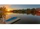 Beautiful waterfront view with a kayak on a private dock at sunset at 3225 Bluff Blvd, Holiday, FL 34691