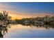 Scenic waterfront view at sunset, reflecting pink and gold hues over calm water and boat docks at 3225 Bluff Blvd, Holiday, FL 34691