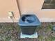 Close up of the home's AC unit on a concrete base surrounded by grass and shrubbery at 3923 W Bay View Ave, Tampa, FL 33611