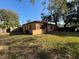 The exterior of this single-story home includes a fenced yard and central AC unit at 3923 W Bay View Ave, Tampa, FL 33611