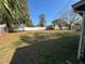 Spacious backyard featuring a white fence and mature trees at 3923 W Bay View Ave, Tampa, FL 33611