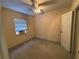 Bedroom includes a ceiling fan, window with blinds, and carpeted floor at 3923 W Bay View Ave, Tampa, FL 33611