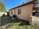 Exterior view of the home showing the AC unit, windows, and side yard at 3923 W Bay View Ave, Tampa, FL 33611