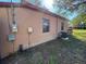 Exterior view of the side of the home showing the exterior utilities and windows at 3923 W Bay View Ave, Tampa, FL 33611