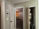 Hallway view showcases doors to bedrooms and utility closet with air conditioning unit at 3923 W Bay View Ave, Tampa, FL 33611