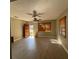 A spacious living room featuring wood-look flooring, a ceiling fan, and natural light from windows at 3923 W Bay View Ave, Tampa, FL 33611