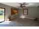 Bright and airy living room featuring wood-look floors, a ceiling fan, and multiple windows at 3923 W Bay View Ave, Tampa, FL 33611