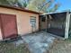 View of screened patio with access to main building and side door to outside at 3923 W Bay View Ave, Tampa, FL 33611