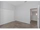 This bedroom features neutral colored carpet with a double closet and access to another room at 7327 Brightwaters Ct, New Port Richey, FL 34652