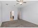 Spacious bedroom featuring carpet flooring and view to the ensuite bathroom at 7327 Brightwaters Ct, New Port Richey, FL 34652